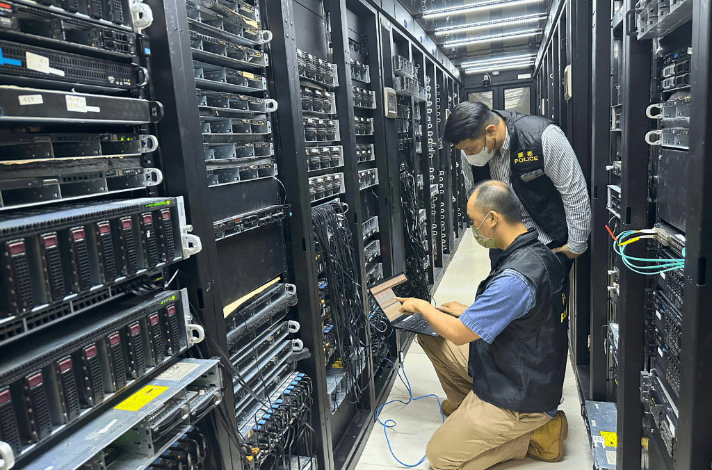 Members of the Hong Kong Police Force raided the premises of the suspects and took more than 1,037 servers linked to malicious services offline. Image credit: INTERPOL and the Hong Kong Police Force